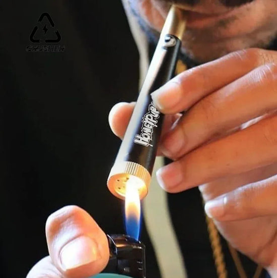Person using a butane lighter with a Black and gold cone-shaped smoking product