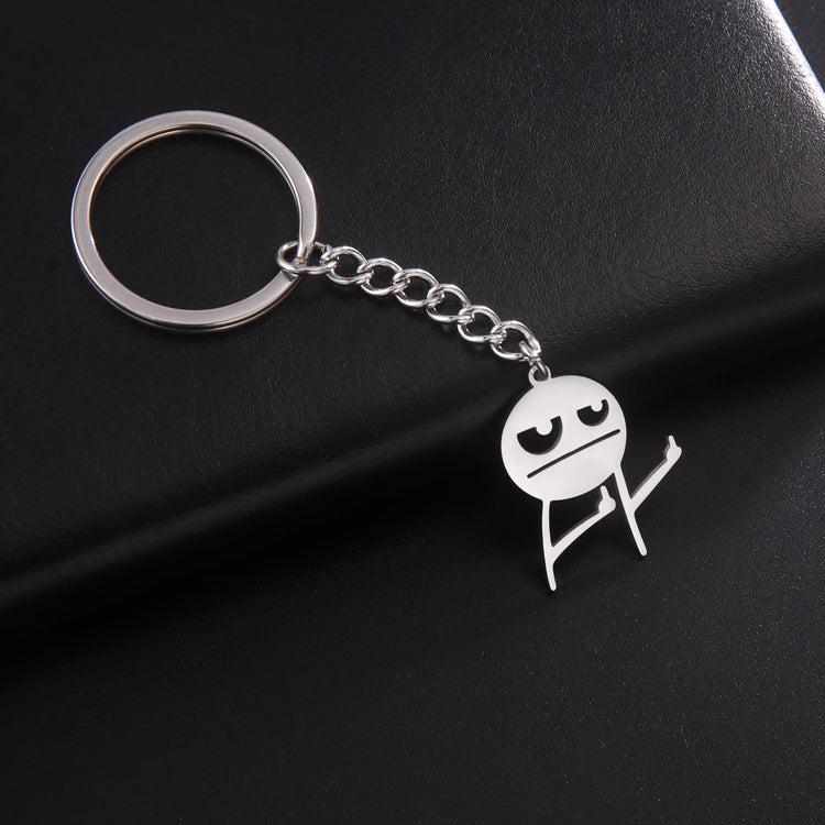 Silver Keychain holding up 2 middles fingers on a black background resting on a leather plate
